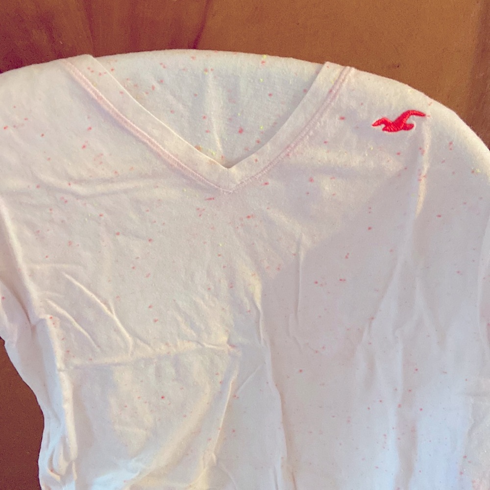 Hollister V-neck tee. Pink and neon yellow speckles throughout the tee.